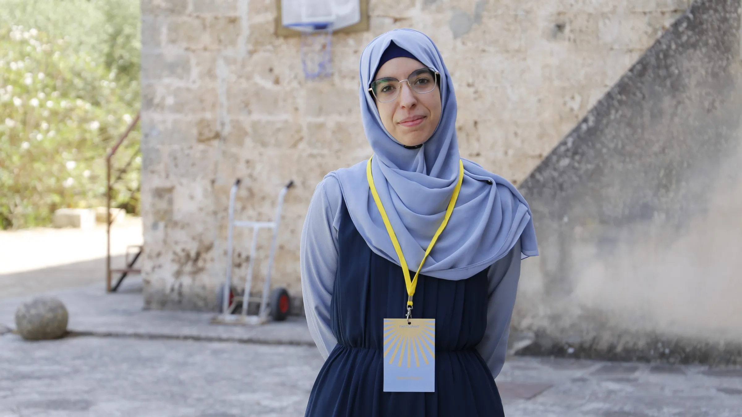 Participant wearing the summer school badge on a yellow lanyard