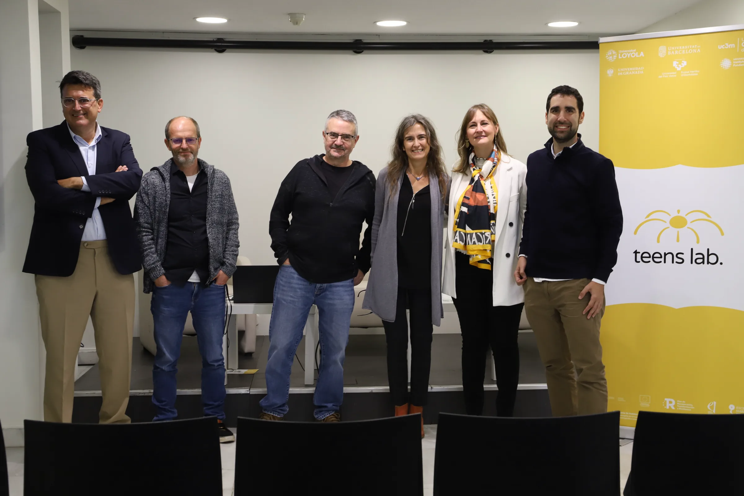 The project team next to the Teens Lab roll-up
